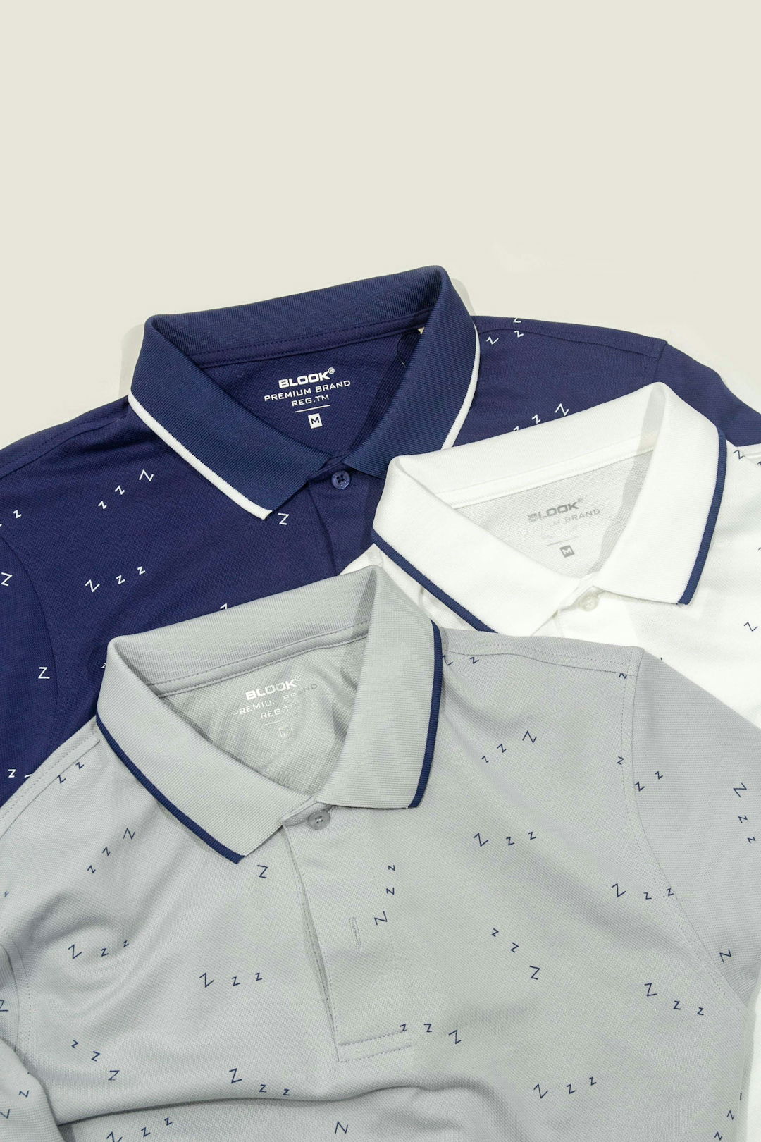 three-men-s-polo-shirts-sitting-next-to-each-other.jpg Three men's polo shirts sitting next to each other